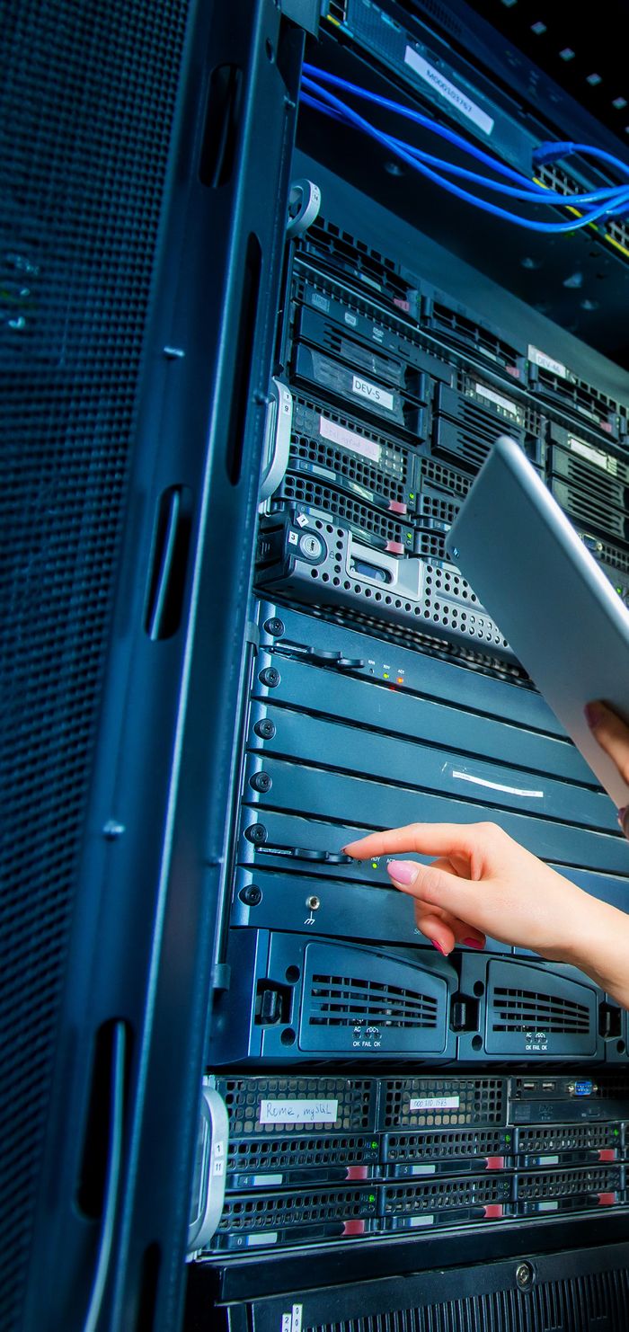 Technician working on server racks representing managed security services